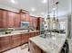 Open kitchen with custom cabinetry, granite countertops, and stainless steel appliances at 2939 Sera Bella Way, Kissimmee, FL 34744