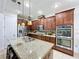 Beautiful kitchen featuring a center island, custom cabinets, and stainless steel appliances at 2939 Sera Bella Way, Kissimmee, FL 34744