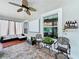 Relaxing lanai featuring comfortable seating, ceiling fan, and a view of the beautifully landscaped backyard at 2939 Sera Bella Way, Kissimmee, FL 34744