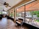 Inviting lanai with seating, ceiling fans, and a view of the backyard featuring a hot tub and gazebo at 2939 Sera Bella Way, Kissimmee, FL 34744