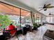 Outdoor living space with an outdoor kitchen, comfortable seating, ceiling fan, and views of the landscaped backyard at 2939 Sera Bella Way, Kissimmee, FL 34744