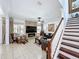 Cozy living room with stone fireplace, mounted flatscreen TV, and comfortable seating at 2939 Sera Bella Way, Kissimmee, FL 34744
