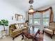 Bright living room with a comfortable sofa, decorative lighting, and large windows with outdoor views at 2939 Sera Bella Way, Kissimmee, FL 34744
