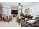 Relax in this cozy living room with a fireplace and comfortable seating at 2939 Sera Bella Way, Kissimmee, FL 34744