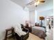 Cozy living area features a futon, chair and doorway to the finished garage at 2939 Sera Bella Way, Kissimmee, FL 34744
