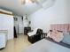 Well-lit living area with a kitchenette, comfortable seating, and neutral decor at 2939 Sera Bella Way, Kissimmee, FL 34744