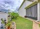 Lush side yard with a variety of plants and shrubs plus covered patio at 2939 Sera Bella Way, Kissimmee, FL 34744