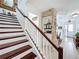 This staircase has wood treads and a white banister and leads to other rooms at 2939 Sera Bella Way, Kissimmee, FL 34744