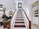 This staircase has wood treads and a white banister and leads to other rooms at 2939 Sera Bella Way, Kissimmee, FL 34744