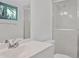 Bathroom featuring a vanity, frosted shower door, toilet, and window at 3 Rosewood Dr, Davenport, FL 33837