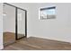 Bedroom featuring new wood floors, white walls, modern window and sliding door at 3 Rosewood Dr, Davenport, FL 33837