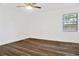 Bright bedroom featuring sleek ceiling fan, wood-look floors, and window at 3 Rosewood Dr, Davenport, FL 33837