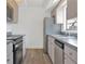 Cozy kitchen with stainless steel appliances, wood cabinets and gray countertops at 3 Rosewood Dr, Davenport, FL 33837
