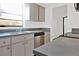 Kitchen featuring stainless steel appliances, wood cabinets, gray countertops, and a double sink at 3 Rosewood Dr, Davenport, FL 33837