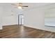 Bright living room featuring new wood floors, ceiling fan, and large window with a view at 3 Rosewood Dr, Davenport, FL 33837