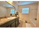 Bathroom featuring a large vanity, garden tub, and ample natural light at 3162 Rodrick Cir, Orlando, FL 32824