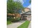 Charming exterior view of a well-maintained townhome with a private driveway and lush landscaping at 3162 Rodrick Cir, Orlando, FL 32824