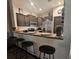 Open kitchen with breakfast bar, dark wood cabinets, stainless steel refrigerator, and granite countertops at 3162 Rodrick Cir, Orlando, FL 32824