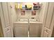 Bright laundry room with washer, dryer, and shelving for storage at 3162 Rodrick Cir, Orlando, FL 32824
