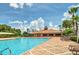 Resort-style community pool with inviting lounge chairs and lush tropical landscaping on a sunny day at 3162 Rodrick Cir, Orlando, FL 32824