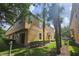 Beautiful exterior view of tan townhouses complemented by lush landscaping and mature trees at 3162 Rodrick Cir, Orlando, FL 32824