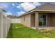 Side backyard view with fence and grass at 326 Highland Meadows Ave, Davenport, FL 33837