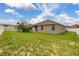 Backyard featuring grass, trees, fencing and the rear of the home at 326 Highland Meadows Ave, Davenport, FL 33837