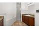 Bright bathroom features a tiled floor, shower, and a separate soaking tub at 326 Highland Meadows Ave, Davenport, FL 33837