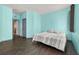 Bedroom with a bed and two windows, and dark hardwood floors at 326 Highland Meadows Ave, Davenport, FL 33837