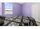 Bedroom with a black and white patterned bedspread and a view to the outside at 326 Highland Meadows Ave, Davenport, FL 33837