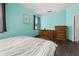 Bedroom with two windows, dark hardwood floors, and calming aqua walls at 326 Highland Meadows Ave, Davenport, FL 33837