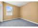 Empty bedroom with carpet, a window, and plain walls at 326 Highland Meadows Ave, Davenport, FL 33837