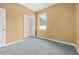 Empty bedroom with carpet, a window, and plain walls at 326 Highland Meadows Ave, Davenport, FL 33837