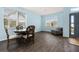 Inviting dining area with natural light, wood floors, and a classic round table with four chairs at 326 Highland Meadows Ave, Davenport, FL 33837