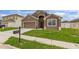 Attractive home with a well manicured lawn, attached two car garage and a classic mailbox near the curb at 326 Highland Meadows Ave, Davenport, FL 33837