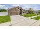 Single-Gathering home boasting a two-car garage, tidy landscaping, and a long driveway at 326 Highland Meadows Ave, Davenport, FL 33837