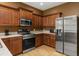 View of the kitchen featuring stainless steel appliances, tiled floor and granite countertops at 326 Highland Meadows Ave, Davenport, FL 33837