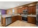 View of the kitchen featuring stainless steel appliances, tiled floor and granite countertops at 326 Highland Meadows Ave, Davenport, FL 33837