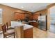 Modern kitchen featuring granite countertops, stainless steel appliances, and a cozy breakfast bar area at 326 Highland Meadows Ave, Davenport, FL 33837