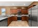 Well-equipped kitchen featuring stainless steel appliances, tiled floor and granite countertops at 326 Highland Meadows Ave, Davenport, FL 33837