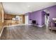 Open-concept living room and kitchen area with wood-look flooring at 326 Highland Meadows Ave, Davenport, FL 33837