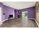 Large living room area with wood-look flooring and lots of natural light at 326 Highland Meadows Ave, Davenport, FL 33837