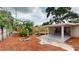 Backyard with covered patio, fire pit, wood fence, and mature landscaping at 3621 Devonswood Dr, Orlando, FL 32806