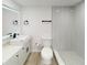 Modern bathroom with white vanity, framed mirror, and glass-enclosed shower with accent tile at 3621 Devonswood Dr, Orlando, FL 32806