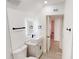 Stylish bathroom features a lighted mirror, vanity, modern fixtures, and tiled walls at 3621 Devonswood Dr, Orlando, FL 32806