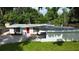 Charming home with a red door, white brick, black shutters, and fresh landscaping on a well-maintained lawn at 3621 Devonswood Dr, Orlando, FL 32806