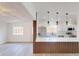 Modern open kitchen featuring quartz countertops, stainless appliances, and bright pendant lighting at 3621 Devonswood Dr, Orlando, FL 32806