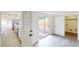 Open living space with wood-look floors, door to yard, and entry to kitchen with stainless appliances at 3621 Devonswood Dr, Orlando, FL 32806