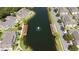 Aerial view of homes surrounding a pond with docks and a water fountain at 4014 Santa Maria Dr # 101, Kissimmee, FL 34741