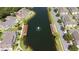 Beautiful aerial view of townhomes by a pond with a fountain and dock at 4014 Santa Maria Dr # 101, Kissimmee, FL 34741